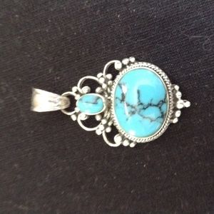 Antique real turquoise in sterling silver pendant. Heavy mounting and hook.